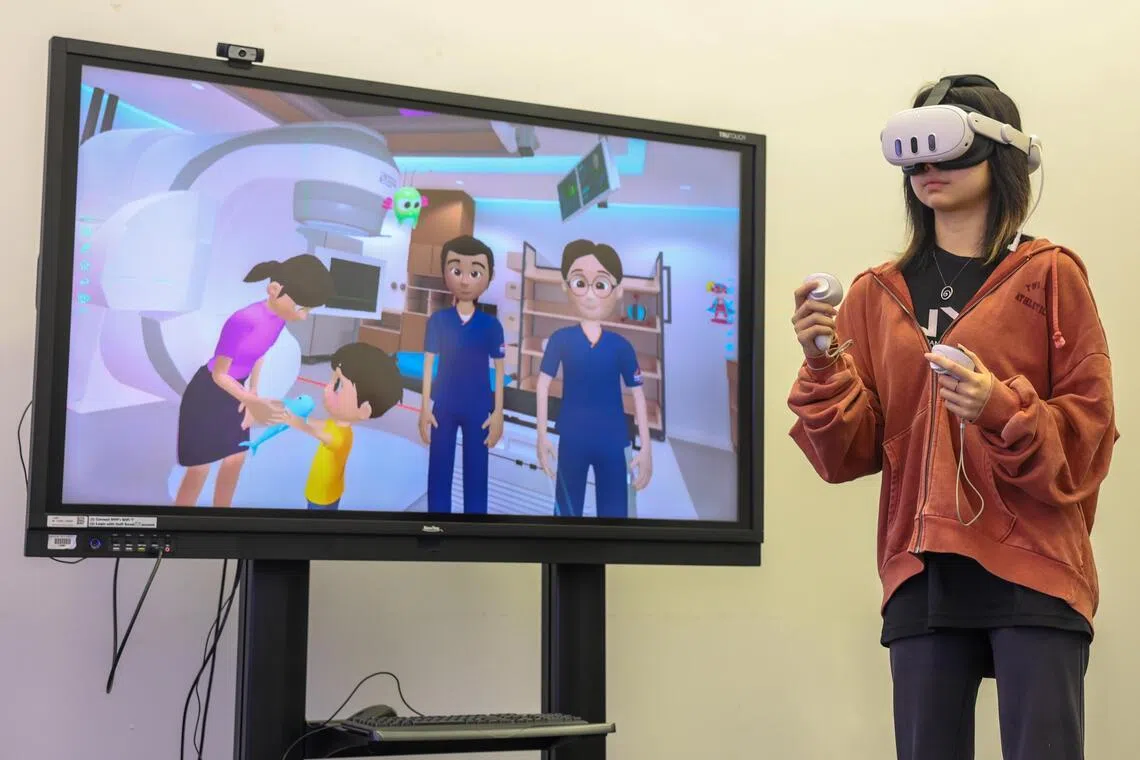 NYP School of Design and Media student Alyssa Tan demonstrates her final-year project, a virtual reality simulation that helps help young cancer patients prepare for radiotherapy treatment. Photo by Jasel Poh/ST
