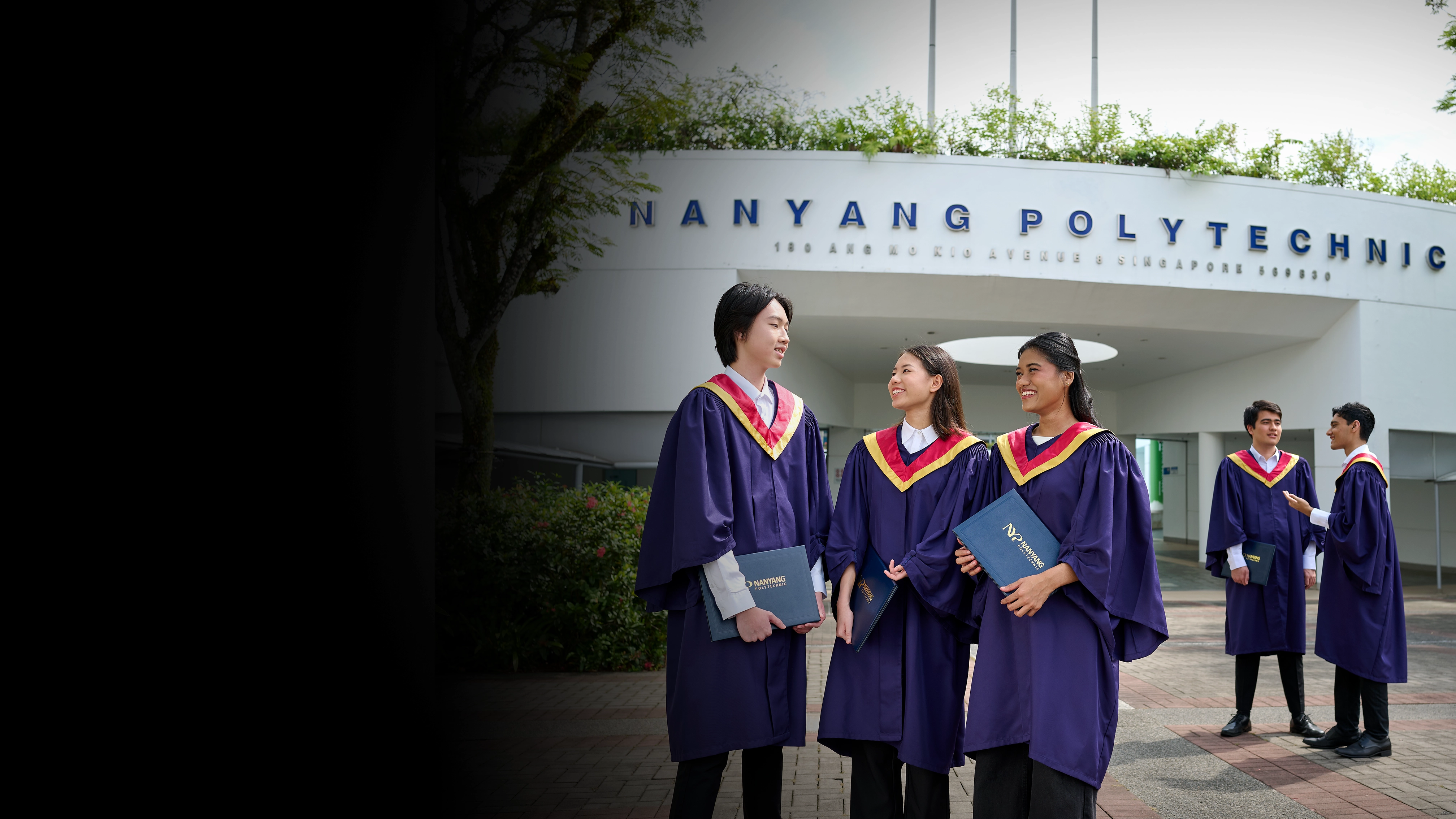 Students in graduation gown standing in front of the Nanyang Polytechnic Campus