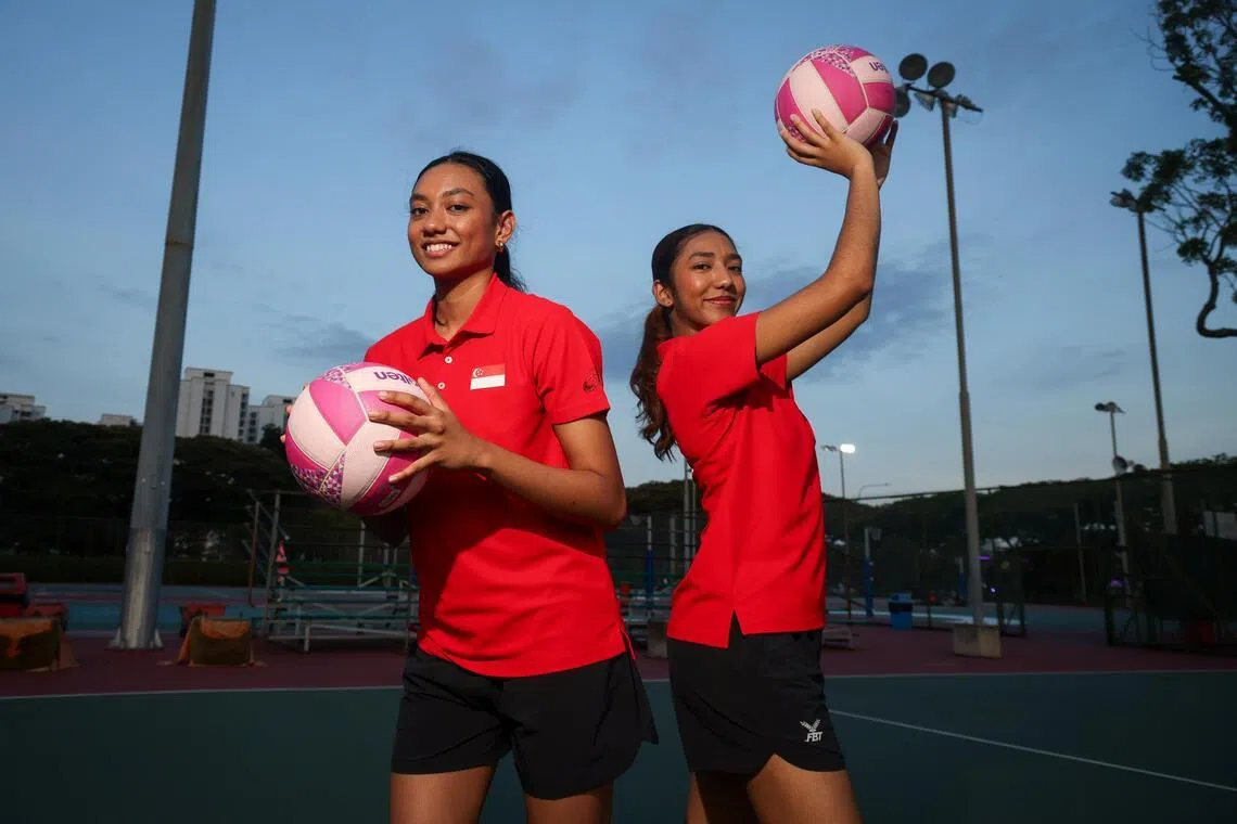Uzma Rashad and Zulfa Rashad posing in a netball court