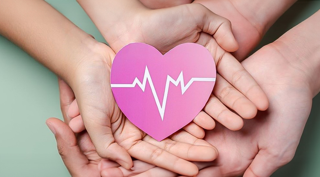 Hands holding a paper heart cutout