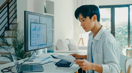 Teen boy analysing data on screen at home