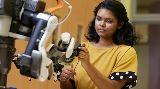 Girl fixing robot