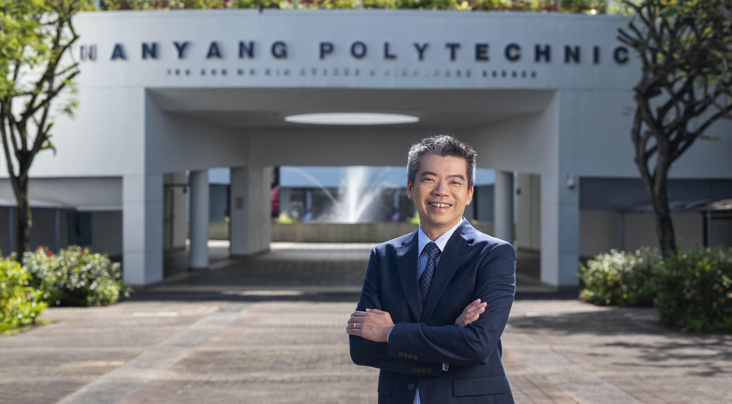 Mr Russell Chan, PCEO, Nanyang Polytechnic, standing in front of the NYP school campus.