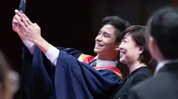 Teen boy analysing data on screen at home