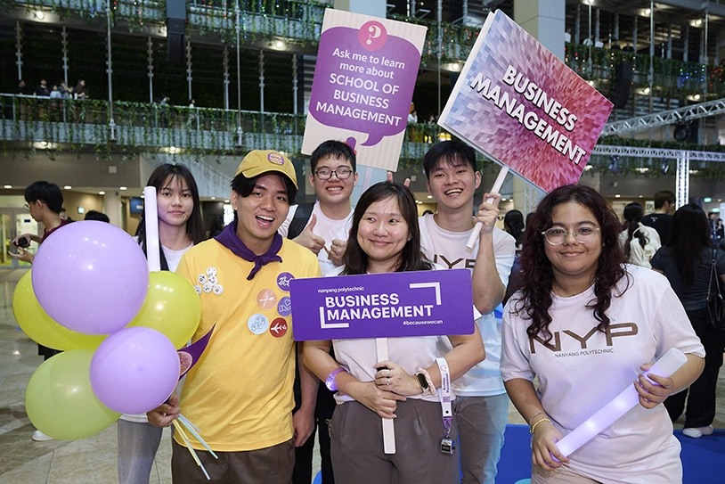 A NYP student talking to two girls.