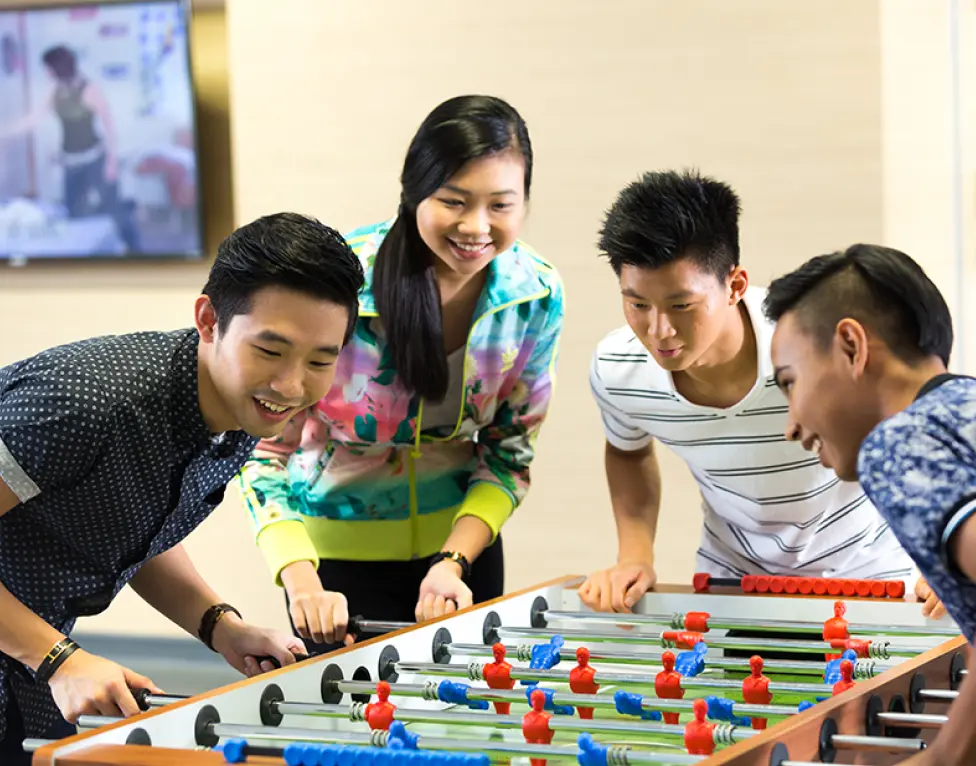 Students playing table football together