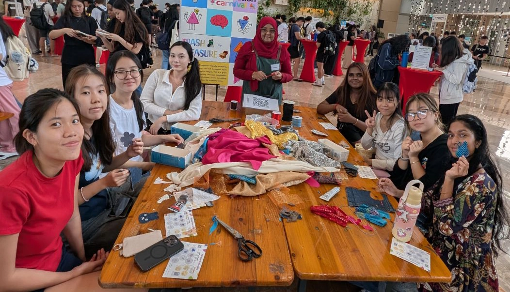 Students making their own little charms out of scrap cloth
