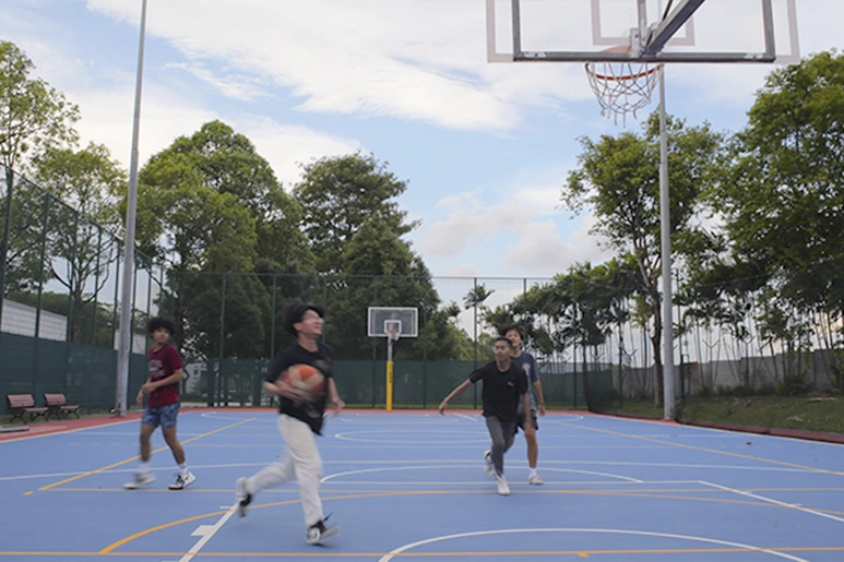 Students casually playing basketball