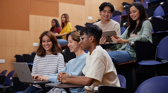 Students browsing their devices in a lecture theatre