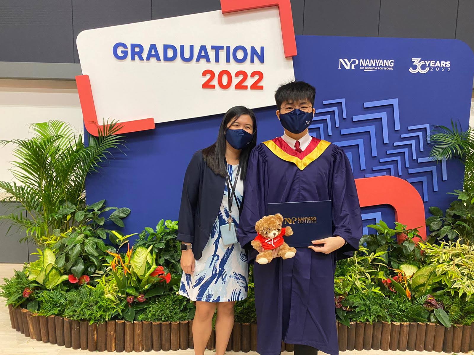 Axel and Ms Joanne Foo in front of the Graduation 2022 photobooth