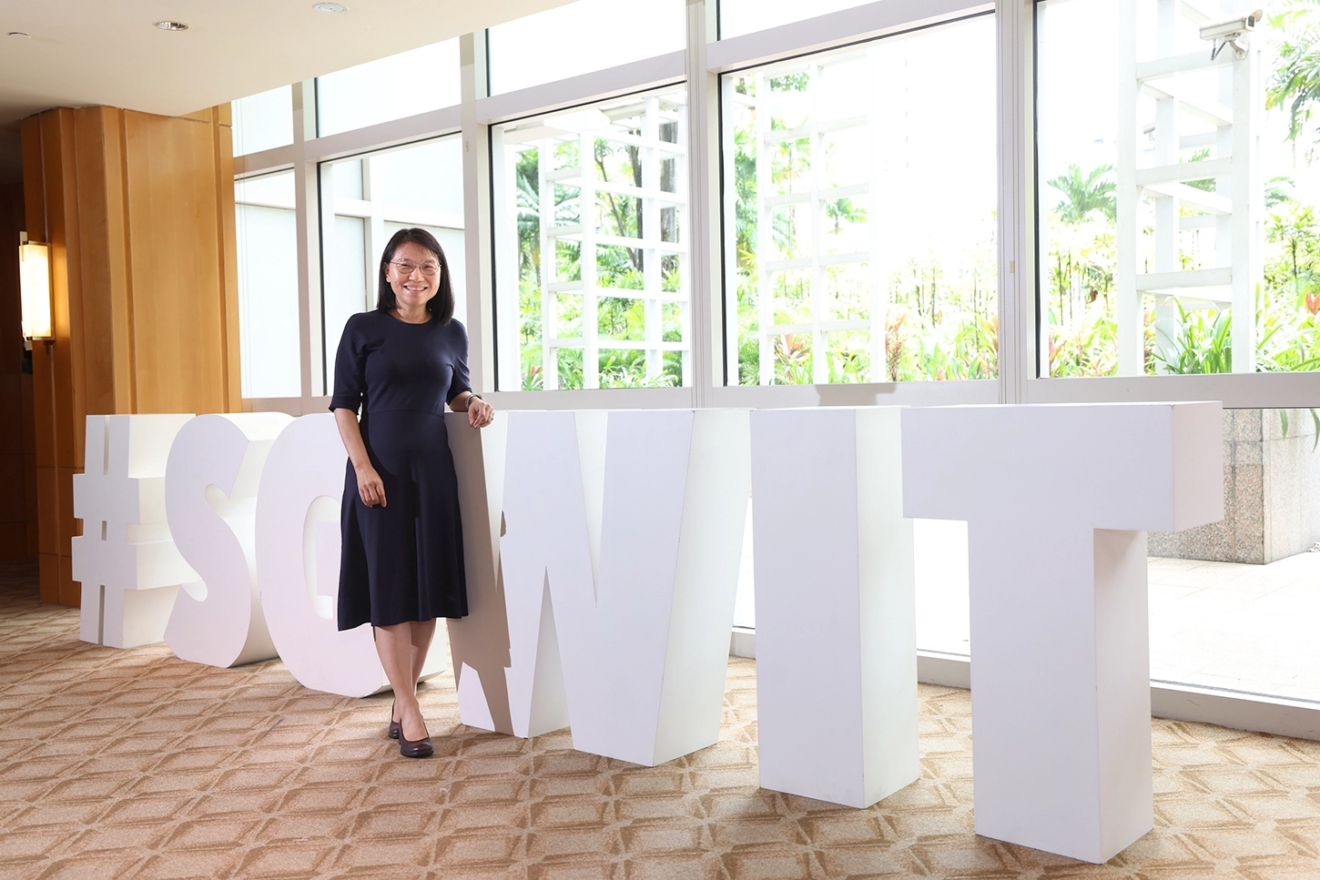 Ms Tan Soon Keow standing in front of the SG Women in Tech (WIT) sculpture