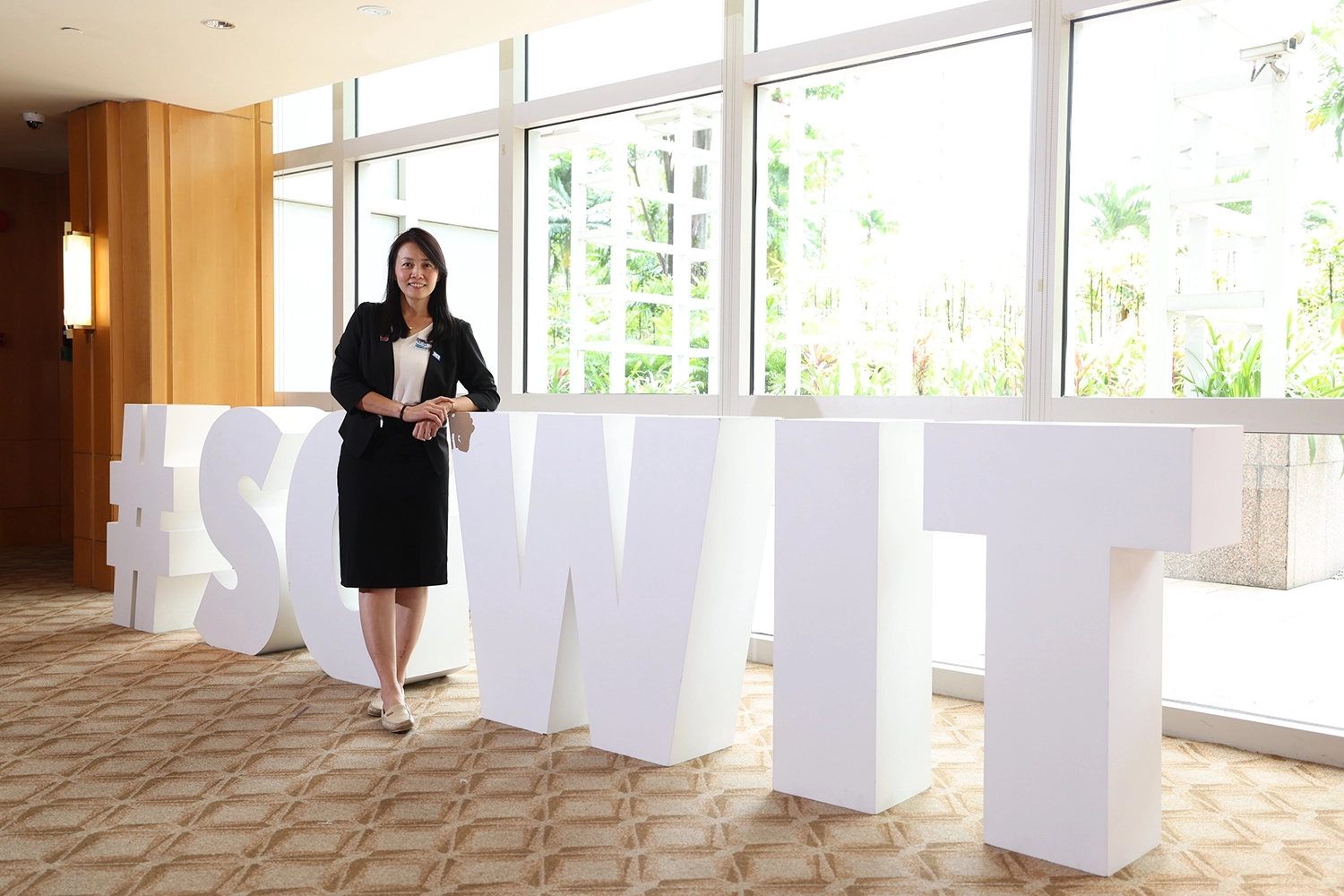 Ms Teo Miow Ting standing in front of the SG Women in Tech (WIT) sculpture
