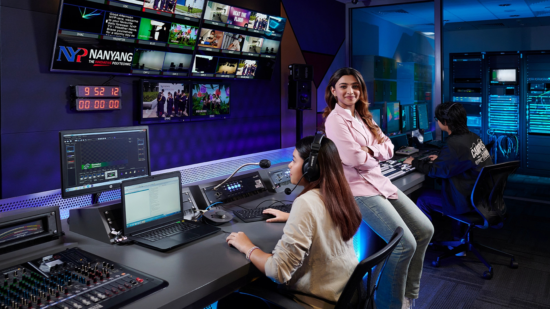A girl confidently looks at the camera in a media production studio.