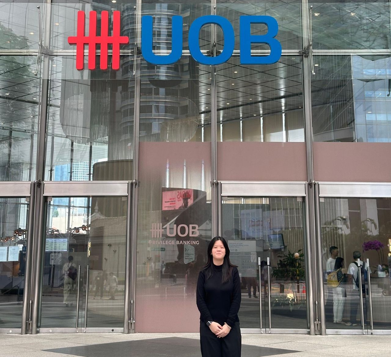 Intern, Lim Ching Kee, standing outside UOB building, reflecting on learning credit analysis, teamwork, and personal growth during internship.