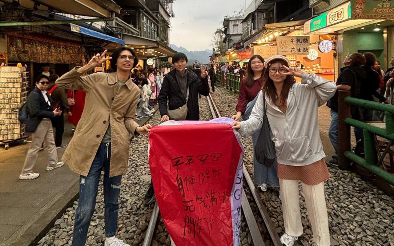 Dobry and Douglas releasing a lantern with fellow interns.