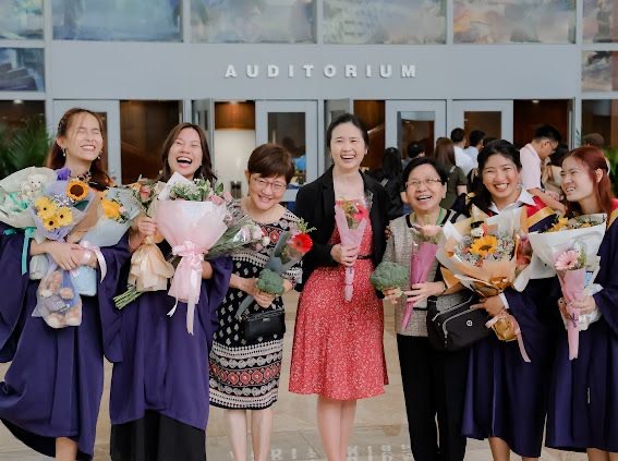 Grace (second from left) with her friends and lecturers on Graduation Day